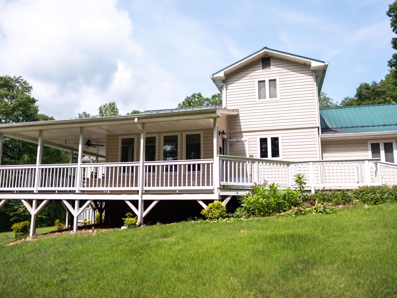 Hidden Mountain House with its wraparound porch and green metal roof